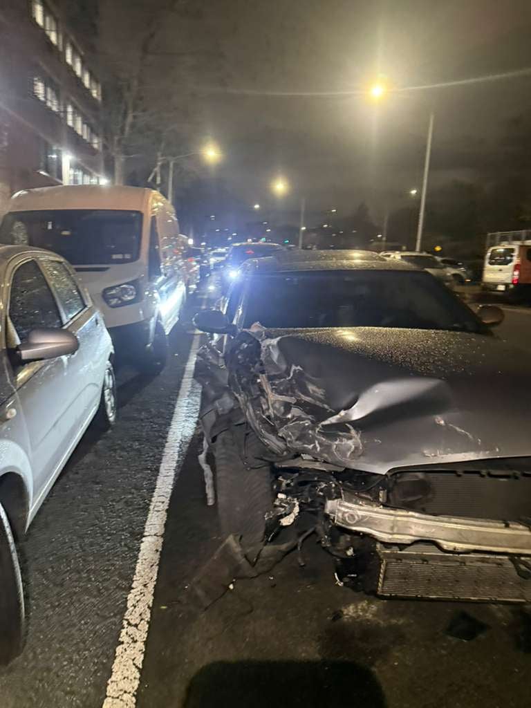 Collision recovery in Queens — front-end damage Sedan with heavy front-end crash damage recovered on a Queens street at night — JG Towing.